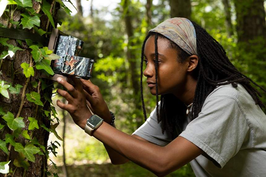 Lavendar Harris checks a wildlife camera in 2022.