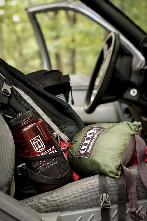 Gear sits in the front seat of a truck.