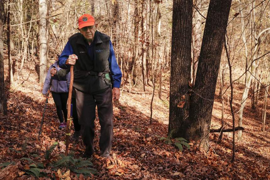 Walter Cook leads a group down a trail at Tallassee Forest