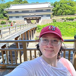 Sarah stands in front of Japanese historical monument.