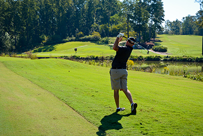 A man tees off at the UGA Golf Course