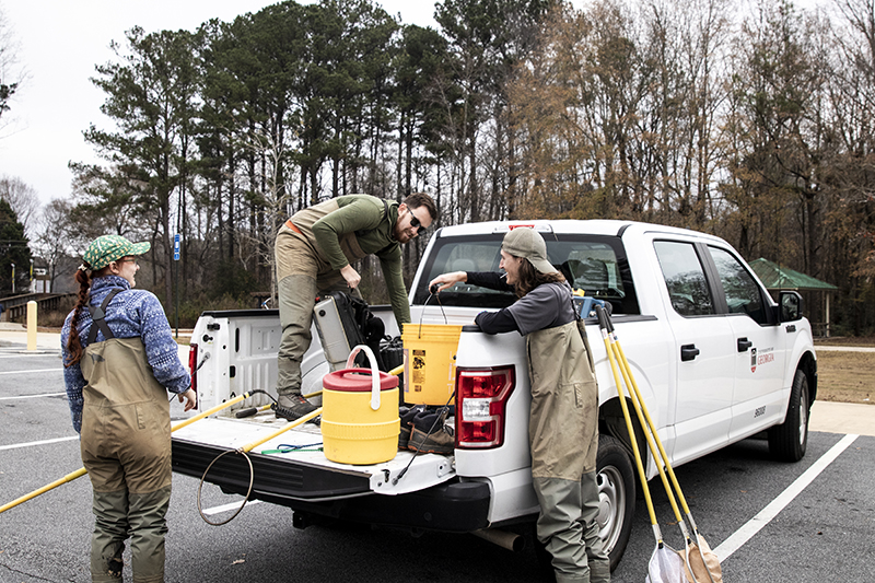 Sarah McNair, Wesley Gerrin and Adam Musolff prepare to search for weather loaches.