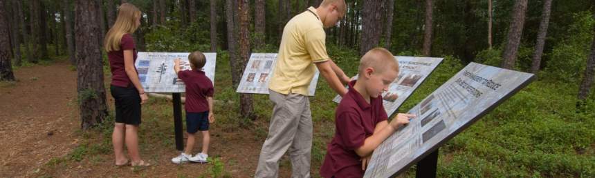 Parents and children look at educational panels