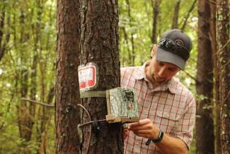 Michel Kohl checks a wildlife camera