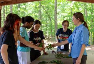 Holly Campbell shows students how to ID leaves