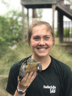 Lizzie Ashley holds a juvenile terrapin before it's released.