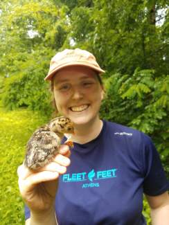 Heather Gaya holds a Canada warbler.