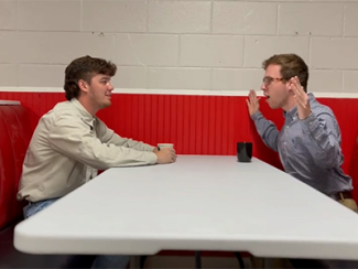 Students sitting at restaurant table talking