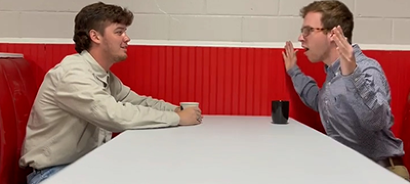 Students sitting at restaurant table talking