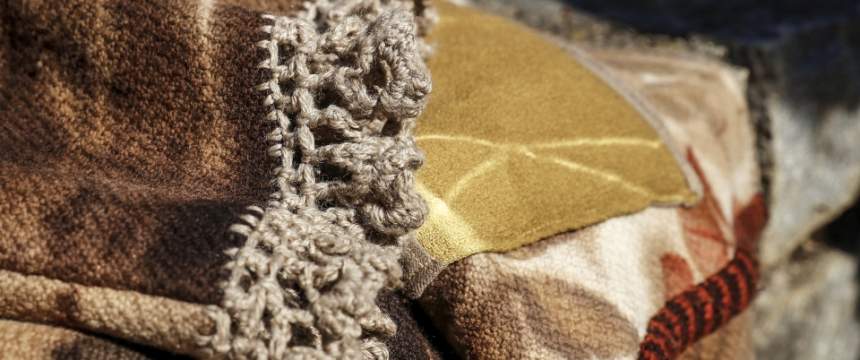 Hand-crocheted detailing on the edge of a natural-dyed coat