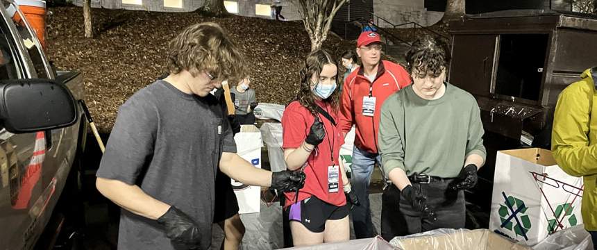 Students measure waste and recycling materials during a recent baseball game
