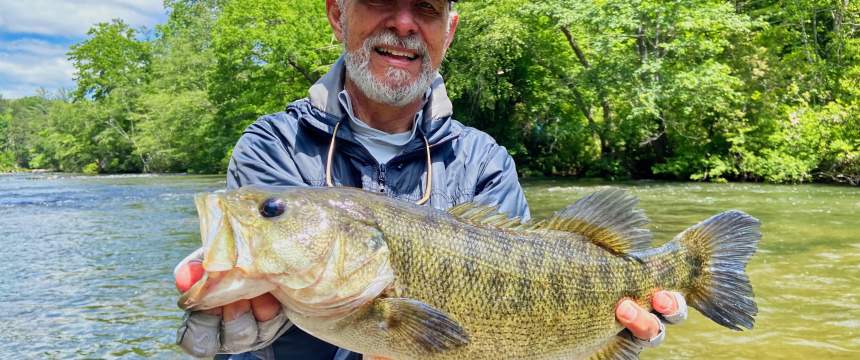 Jimmy Harris holds a bass caught in the Chattahoochee River.