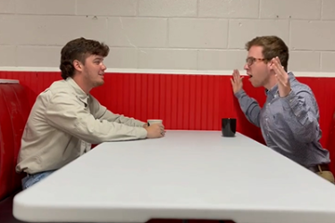 Students sitting at restaurant table talking