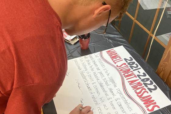 Jack DeRochers signs the Warnell Ambassadors' mission statement for the 2021-2022 academic year