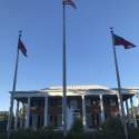 The governor's mansion is framed by flags