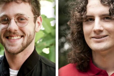 Side-by-side portraits of two young men outdoors; one has short hair, glasses, and a beard, the other has long curly hair and is wearing a red shirt.
